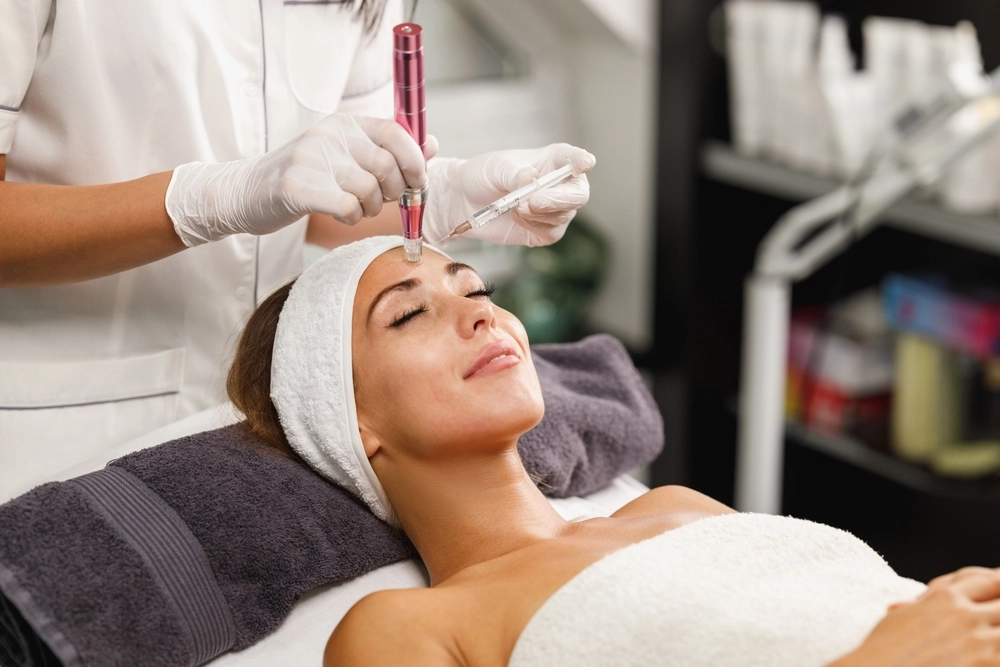 Shot of a beautiful young woman on a facial dermapen micro-needling treatment at the beauty clinic.